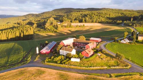 an aerial view of a farm with a truck on a road at Munkeby Herberge in Levanger