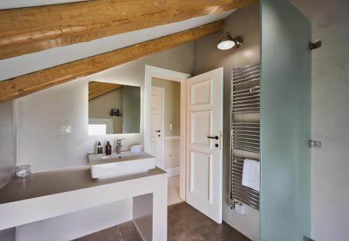 a bathroom with a sink and a mirror at Varaba Country House in Markopoulo