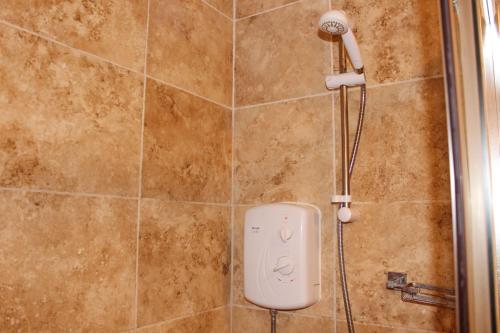 a shower with a white controller in a bathroom at Contemporary near city apartment, free parking and wifi, perfect for contractors in Wolverhampton