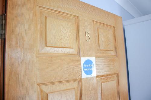 a wooden door with a sign on it at The Coach Inn in Strabane