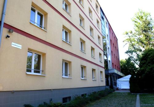 a tall building with windows on the side of it at Hotel Malinowski Economy in Gliwice