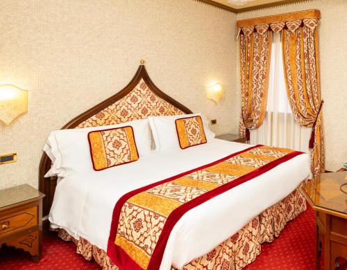 a bedroom with a large bed in a hotel room at Ai Mori d'Oriente in Venice