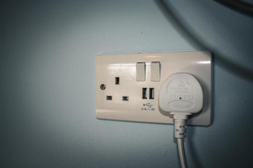 a white outlet with a cord plugged into it at The Coach Inn in Strabane