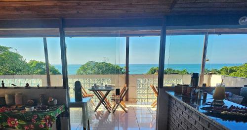 a living room with a view of the ocean at Pousada Encontro das Águas in Trindade