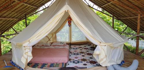 a bedroom with a tent with a bed in it at IKWAI Camping in Ban Hom Kret (2)