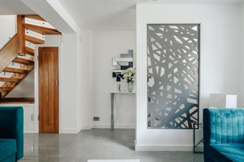 a living room with a door with a pattern on the wall at Exceptional Whole House Chelsea with Roof Terrace in London