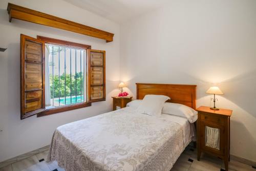 a bedroom with a bed and a window at Villa Maria By Solymar Holiday in Alhaurín de la Torre