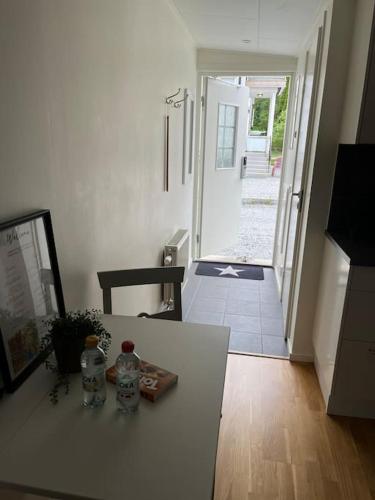 a room with a table with two bottles of water on it at Modernt boende med god tillgänglighet. in Alingsås