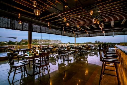 - un restaurant avec des tables et des chaises et une vue sur l'eau dans l'établissement Rupal Residency, à Jaisalmer