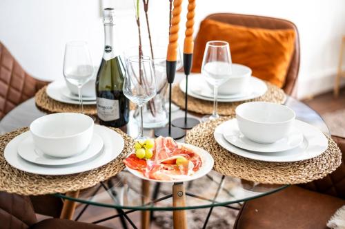 a glass table with a plate of food on it at The London Perfect Attic - sleeps 8 in London