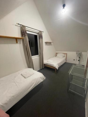 a room with two beds and a sink and a window at Domek blisko granicy u Darka in Kunowice