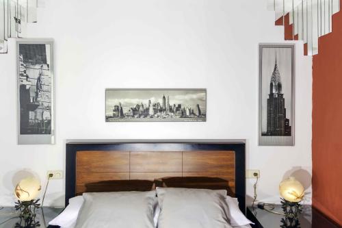 a bedroom with a bed and some pictures on the wall at Hotel Utopía in Benalup Casas Viejas