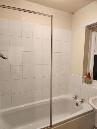 a bathroom with a shower and a tub and a sink at Single Bedroom TDC Greater Manchester in Middleton