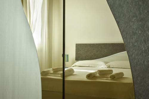 Postel nebo postele na pokoji v ubytování Welc-ōM Casa a colori nel borgo