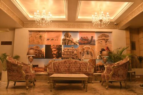 a living room with two couches and a table at Rupal Residency in Jaisalmer