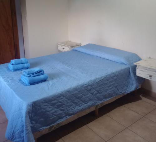 a blue bed with two blue towels on it at Cabaña Emilio (El Hoyo) in El Hoyo