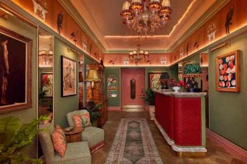 a hallway with green walls and a chandelier at Broadwick Soho in London