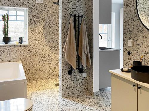 ein Bad mit einer Dusche und einem Waschbecken in der Unterkunft Holiday home LJUNGBY III in Ljungby