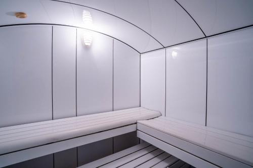 an empty locker room with white walls and a ceiling at Hotel Bartos in Almussafes