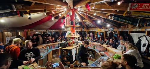 a crowd of people standing in a bar at Haus Capricorn - Appartement Mountain View in Gargellen