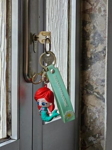 a key tag on a door with a doll on it at Dreamer's Home Chrisa in Limenas