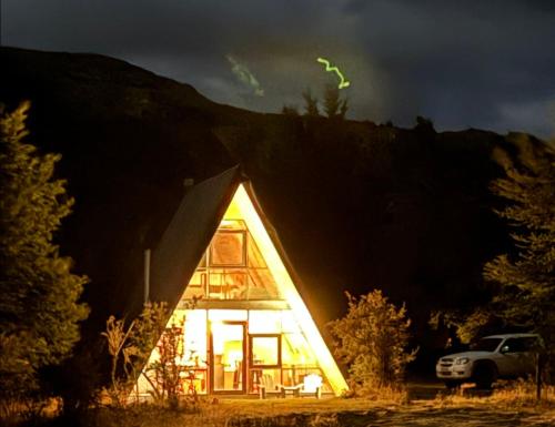 a house that is lit up at night at OUTSCAPE l Cabaña Familiar en mejor sector de Cerro Castillo in Villa Cerro Castillo