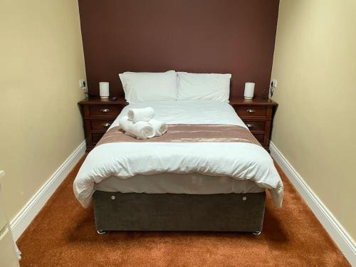 a teddy bear sitting on top of a bed at The Sardinian Guesthouse (6 Bedrooms) in Cobh