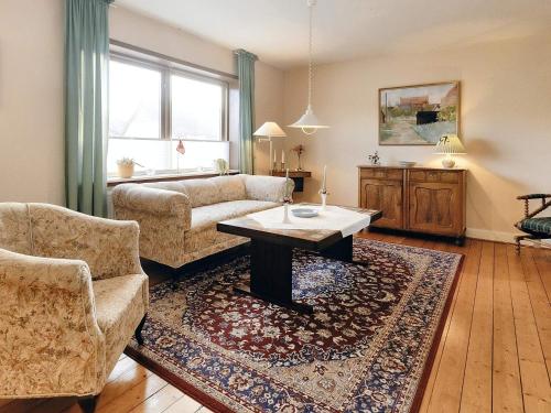 a living room with a couch and a coffee table at 5 person holiday home in Læsø-By Traum in Læsø