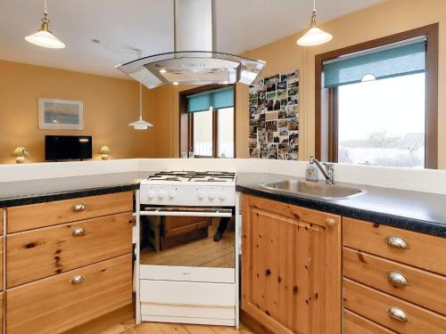 a kitchen with a stove and a sink at 5 person holiday home in Læsø-By Traum in Læsø