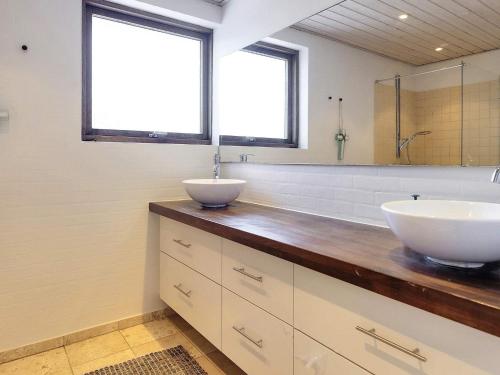 a bathroom with two sinks on a wooden counter at Holiday home Skagen XXXVI in Skagen