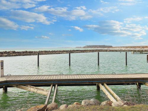 a wooden dock in the middle of a body of water at Beautiful holiday home in Borre-By Traum in Borre
