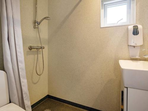 een badkamer met een douche, een toilet en een wastafel bij Holiday home Bogense XLVIII in Bogense