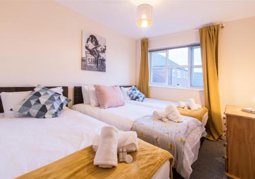 a bedroom with two beds and a window at Derby Parliament Spacious 2Bedroom Apartment with Parking in Derby