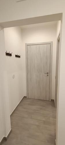 an empty room with a door and a wooden floor at Casa di Nonna Margherita in Trecase