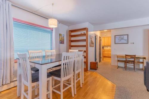 a kitchen and dining room with a table and chairs at The Cozy Harriet Log Home in Fairbanks