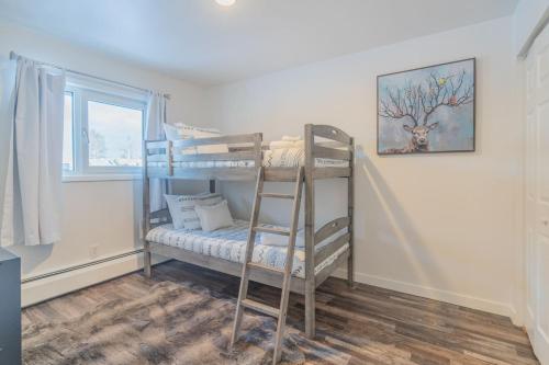 a bedroom with two bunk beds and a window at Alaska Daydream Retreat Near Downtown in Fairbanks