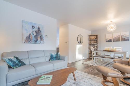 a living room with a couch and a table at Alaska Daydream Retreat Near Downtown in Fairbanks