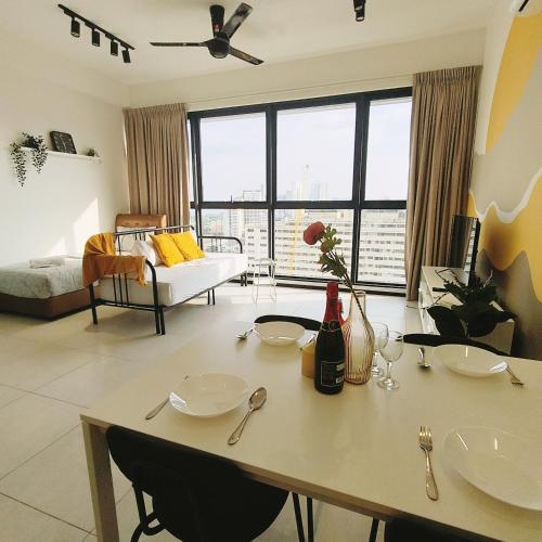 a living room with a table with two chairs at Cozy & Drive Urban Suite by WL in Jelutong