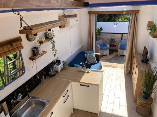a kitchen and living room in a tiny house at The HorseBox a tiny villa in Souda