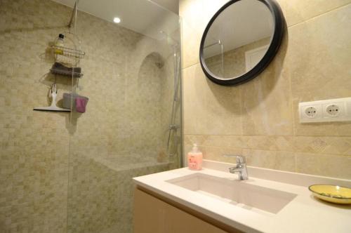 a bathroom with a sink and a mirror and a shower at ROCAMAURA 3 - L'Estartit in L'Estartit