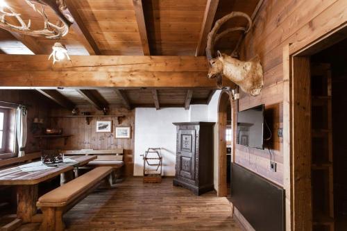 a room with a bench and a table in a cabin at Chalet Edelweiß in Saalbach Hinterglemm