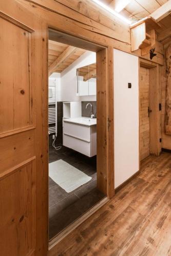 a kitchen with a mirror and a sink in a room at Chalet Edelweiß in Saalbach Hinterglemm