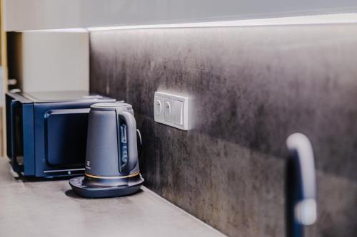 a appliance sitting on a counter next to a wall at Rezidence Petra Voka in Třeboň