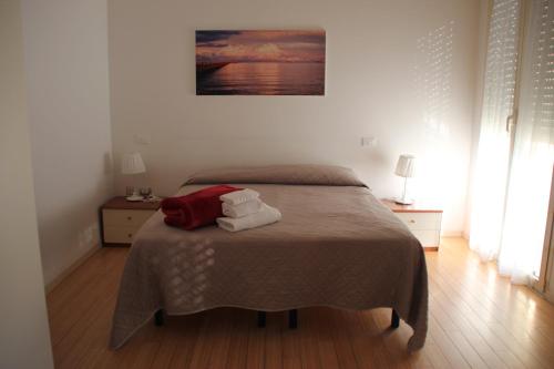 a bedroom with a bed with two towels on it at Residence Rivaverde in Marina di Ravenna