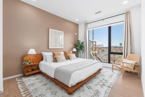 a bedroom with a large bed and a large window at Penthouse Condo on River with Garage and Patio, Walk Downtown in Nashville