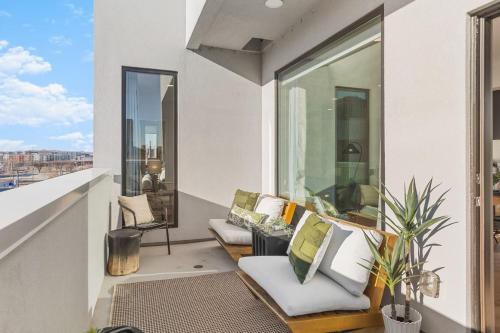 a balcony with white furniture and a view of a city at Penthouse Condo on River with Garage and Patio, Walk Downtown in Nashville