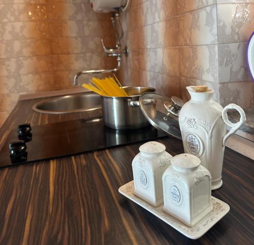 a kitchen counter with two white vases and a sink at Guest House Katić in Dubrovnik