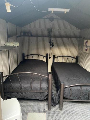 two twin beds in a room with at Margaritas Eco Haus in Querétaro