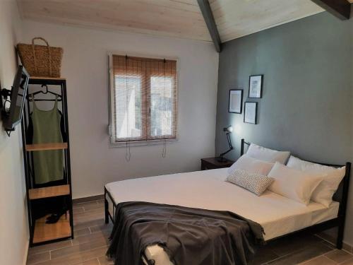 a bedroom with a large bed in a room at Thasos Bespoke Haven - Meltemi Summer Retreat! in Limenaria
