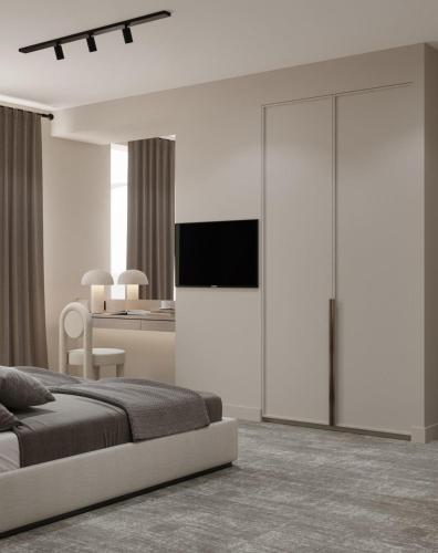 バクーにあるDastan Hotel Bakuのベッドルーム1室(ベッド1台、壁にテレビ付)